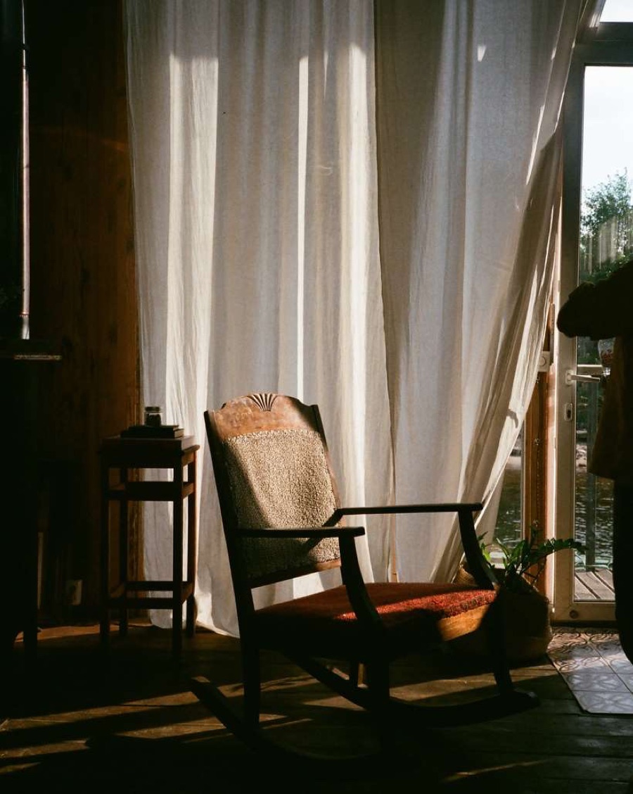 Generic interior-mood stock image — rocking chair in warm window light — representative illustration only, not a developer kit photograph or a Gaurs Studio Bento unit render